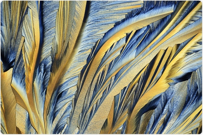 Photo through a microscope of crystals growing from the melt of sulfur. Polarized light technology. Image Credit: alex7370 / Shutterstock